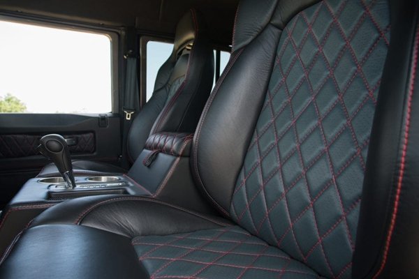 Land rover defender 130 interior with black leather and red stitching