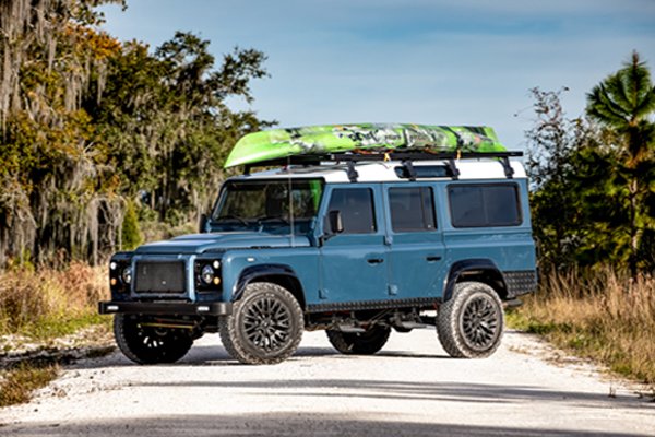 Custom D110 with a kayak on the top of the hardtop