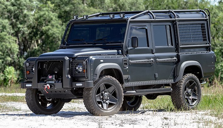 Blacked out custom defender 110 in the dirt